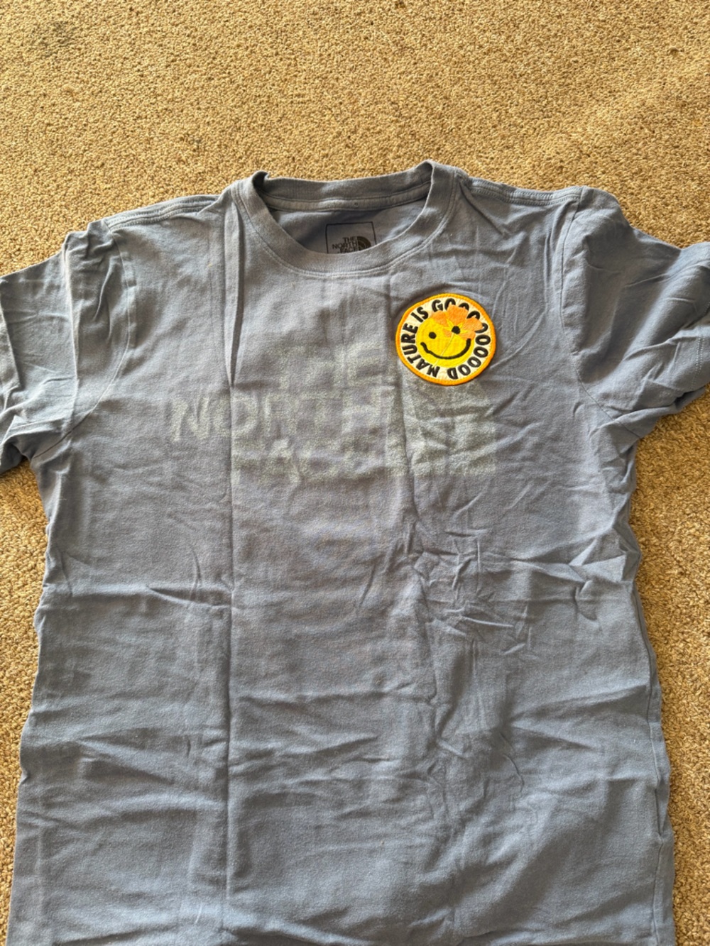The North Face Light Blue Tee with Yellow Smiley Patch